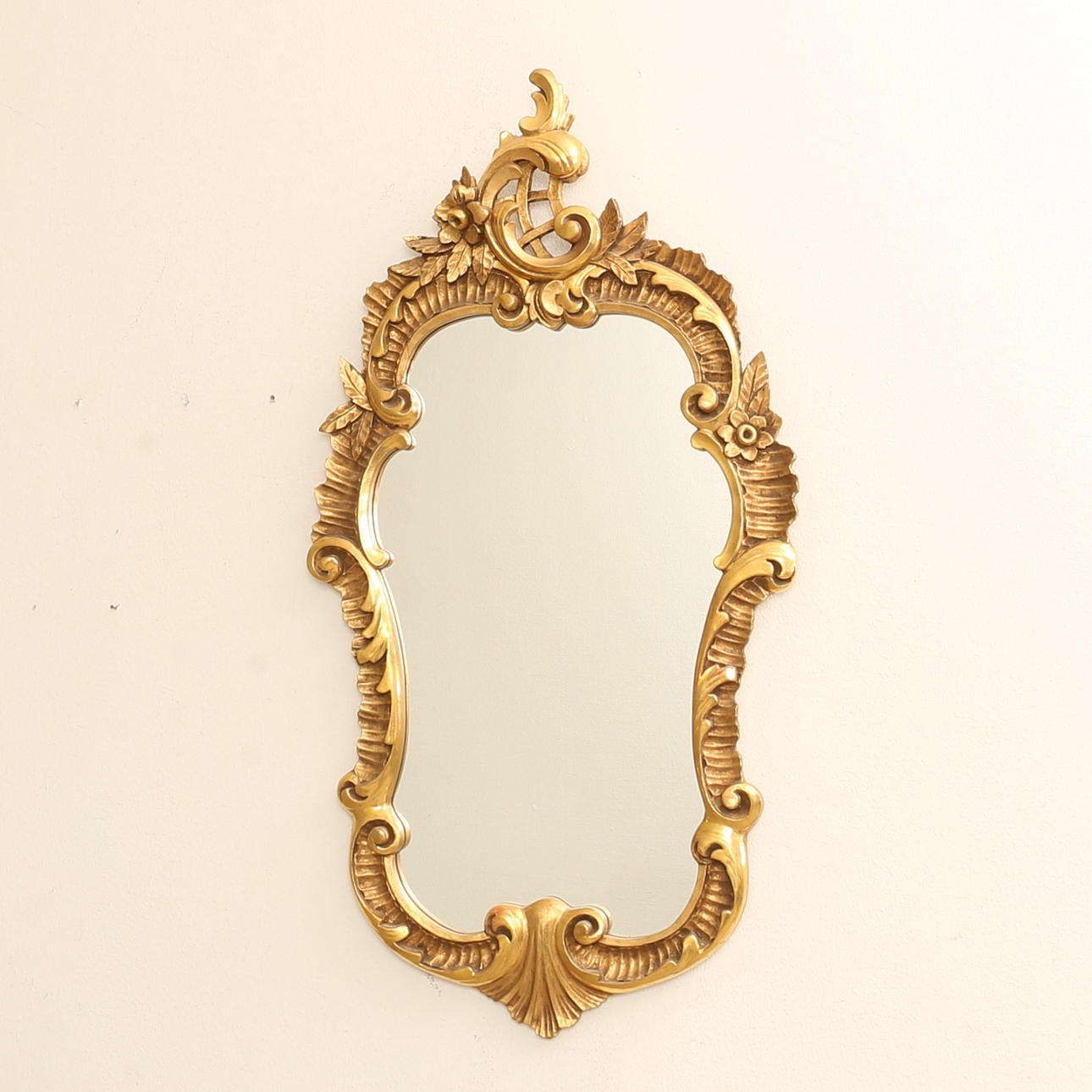 A rococo style mirror, gilt and bronzed, 20th century.