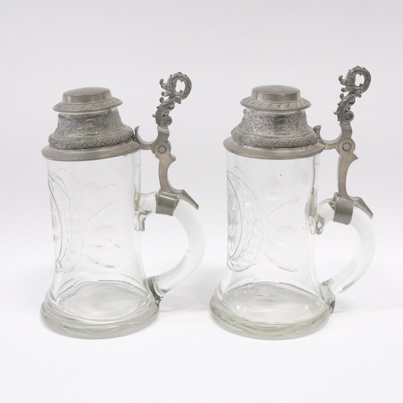 TWO GLASS AND TIN STOPS, CIRCA 1900.