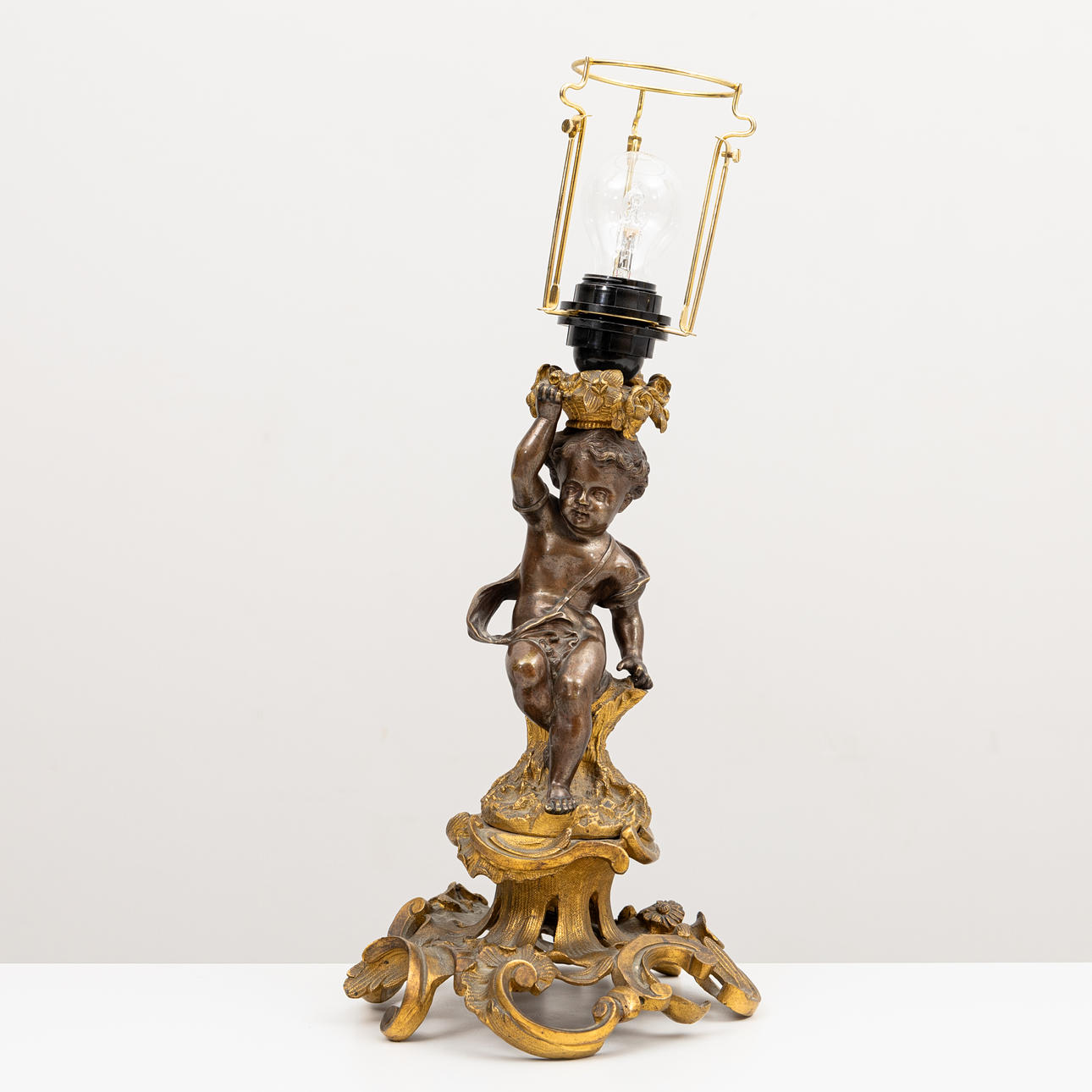 A late 19th century bronze table lamp, patinated and partly gilded.