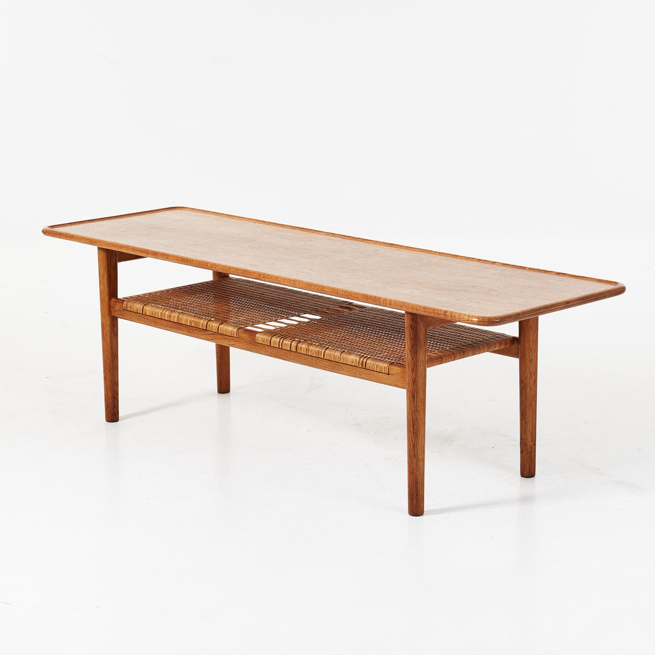 HANS J WEGNER. Coffee table, Andeas Tuck, oak, shelf with wicker rattan, branded bottom.