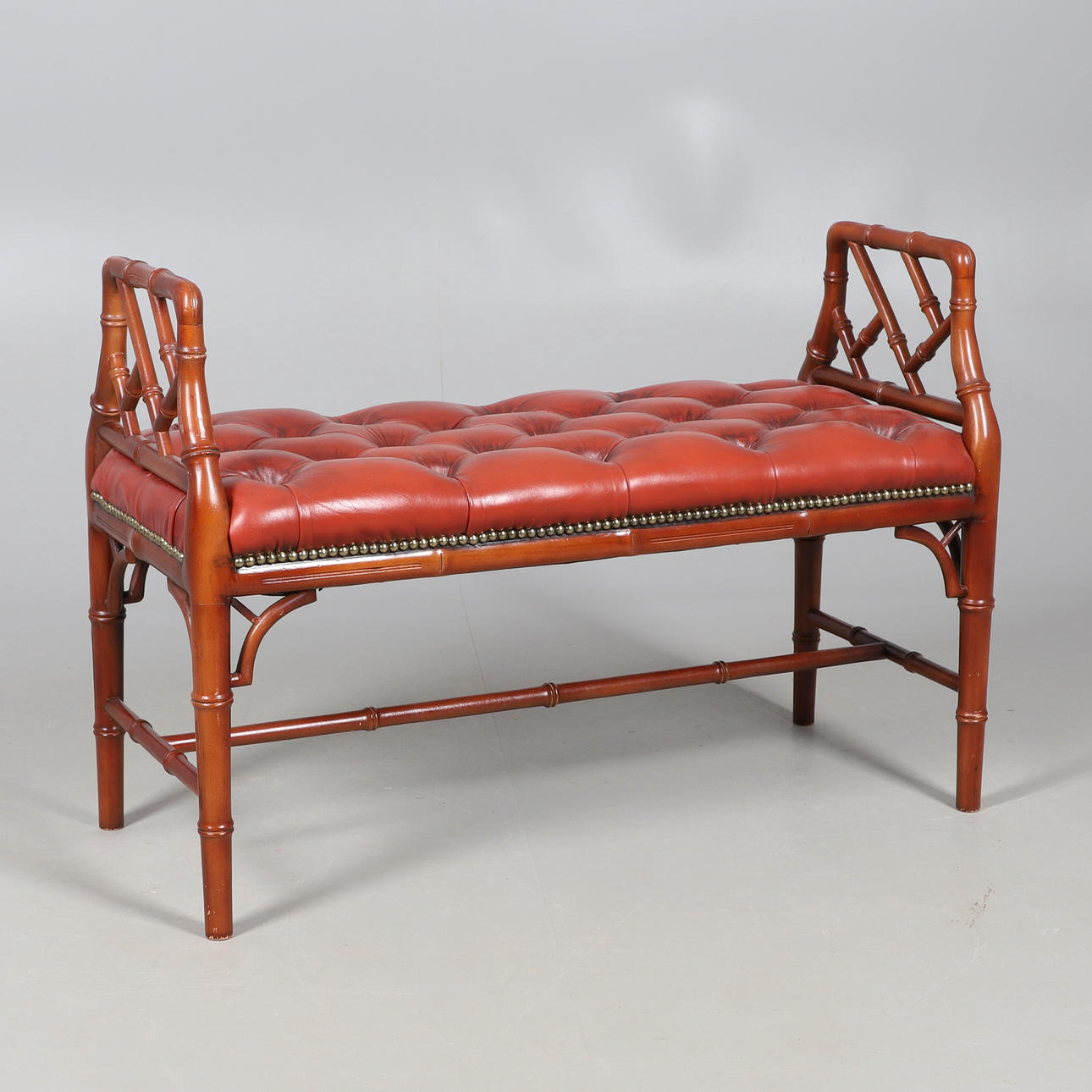 A BAMBOO EFFECT BUTTON LEATHER SEATED STOOL.