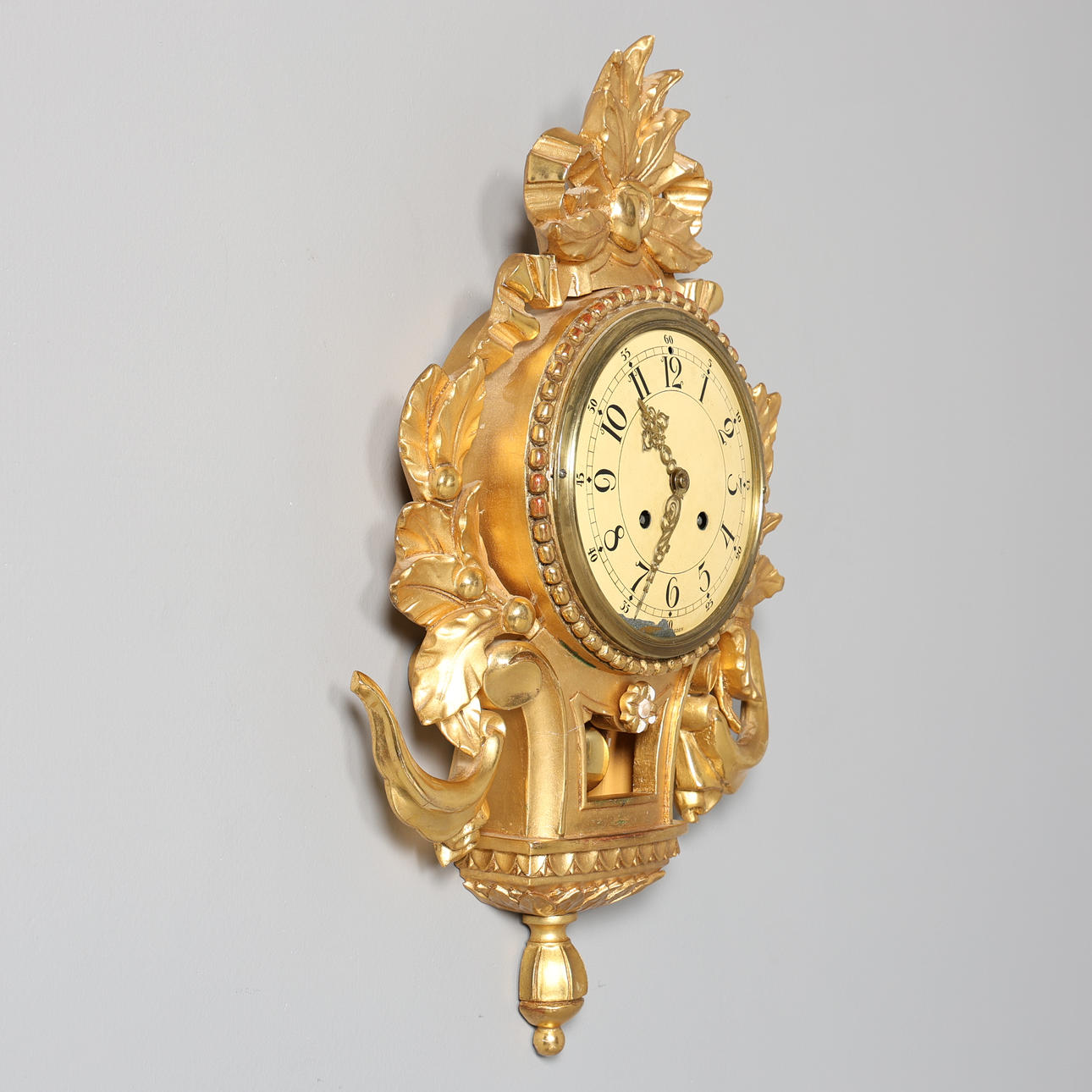 A 20th century gold pendyle wall clock.