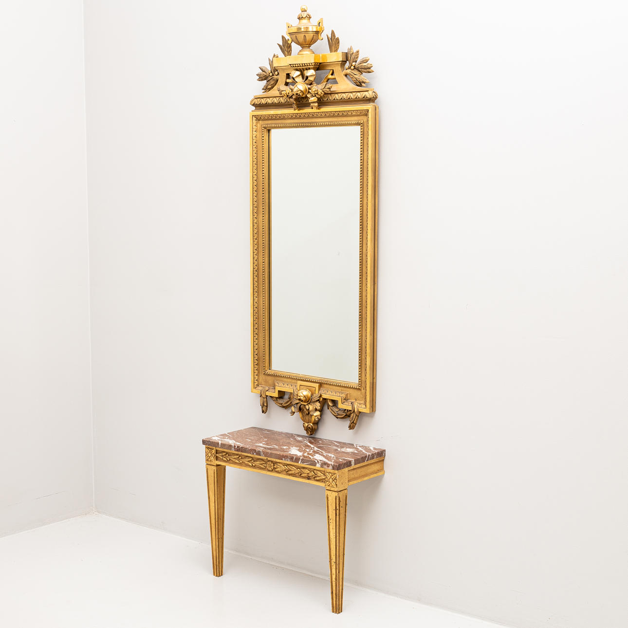 A Gustavian-style mirror and console table, the mirror labeled Åke Österlunds Förgylleri, second half of the 20th century.