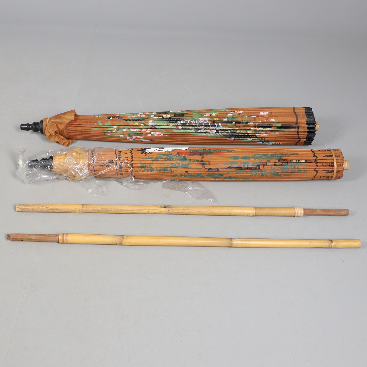 TWO ORIENTAL PARASOLS / UMBRELLAS.