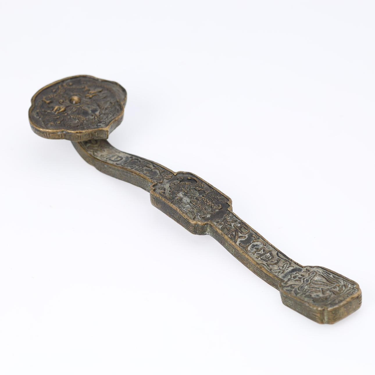 Ruyi scepter of bronze, decorated with various motifs, China.