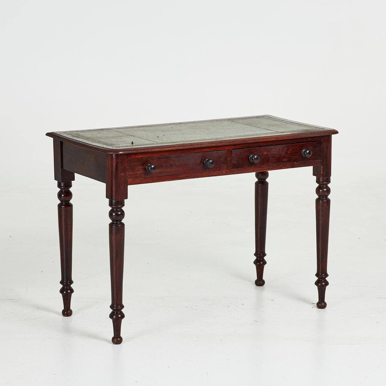 DESKS. Second half of the 19th century, turned legs, profiled edge, top with inlaid embossed leather.