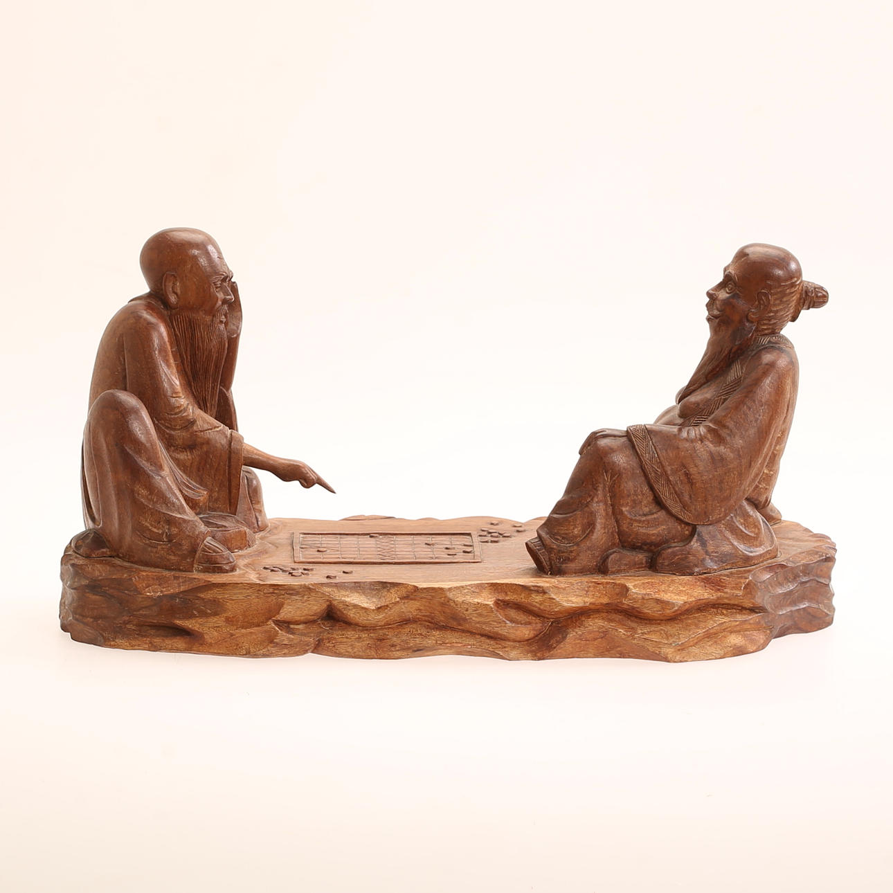 SCULPTURE, wood, playing men, signed.