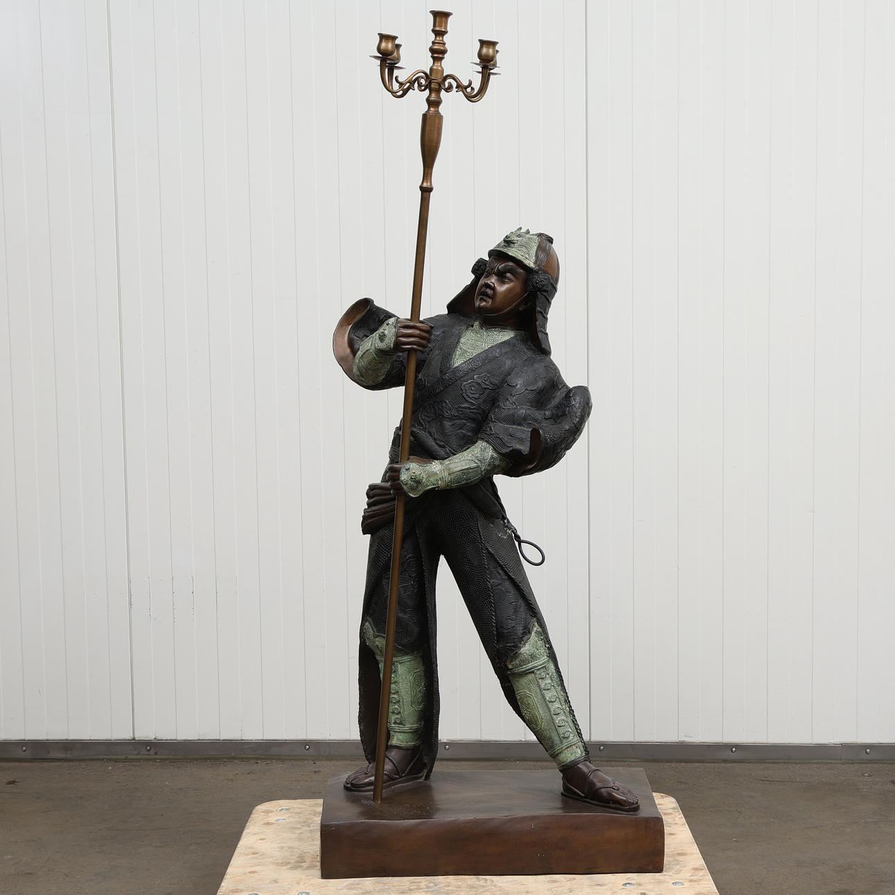 A BRONZE SAMURAI SCULPTURE with candelabra.
