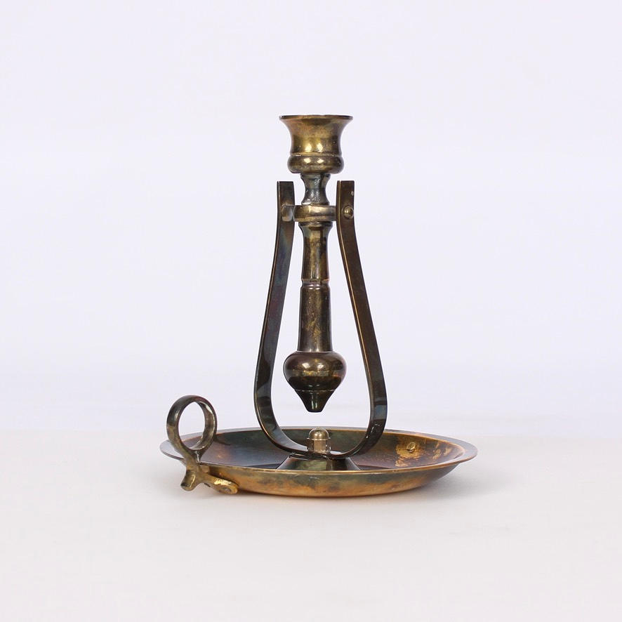 A 20th-century brass scepter candlestick.