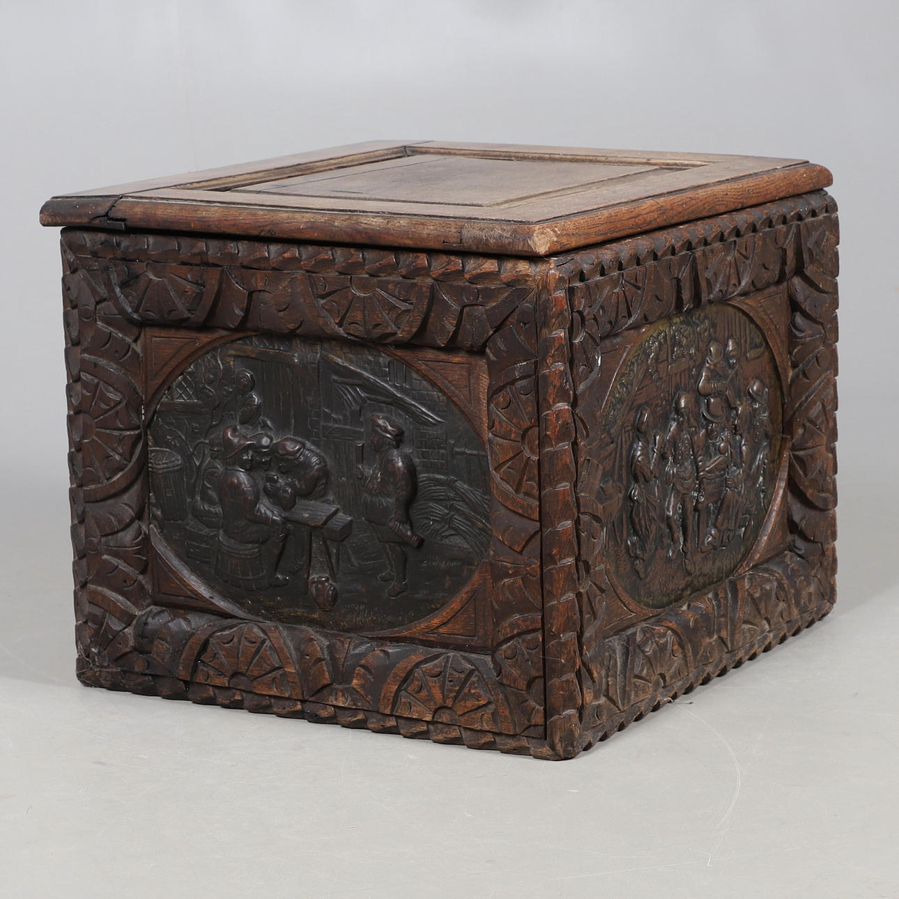 A CARVED OAK COAL BOX.
