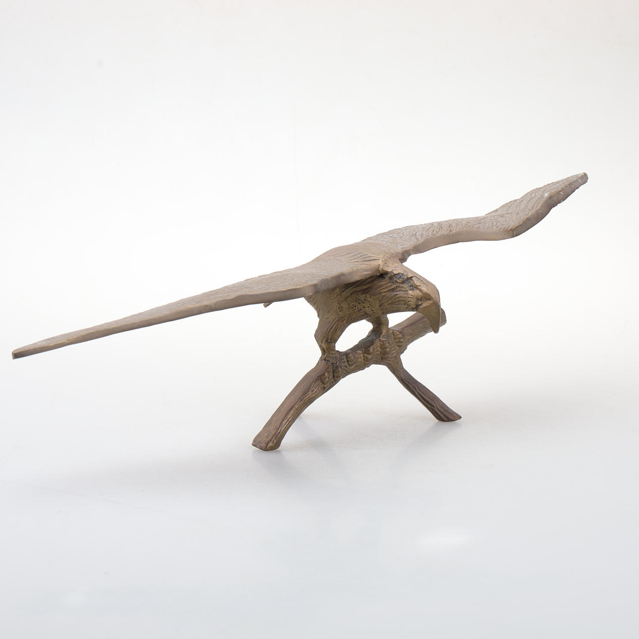 A brass eagle figurine.