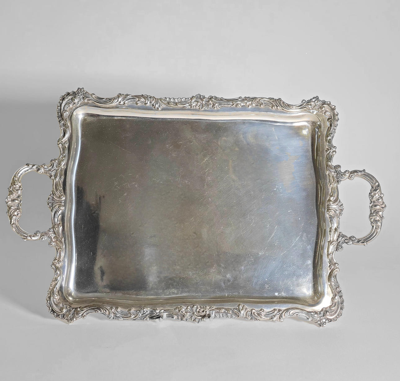 SILVER TRAY WITH DOUBLE HANDLE AND VEGETABLE PERIMETER DECORATION.