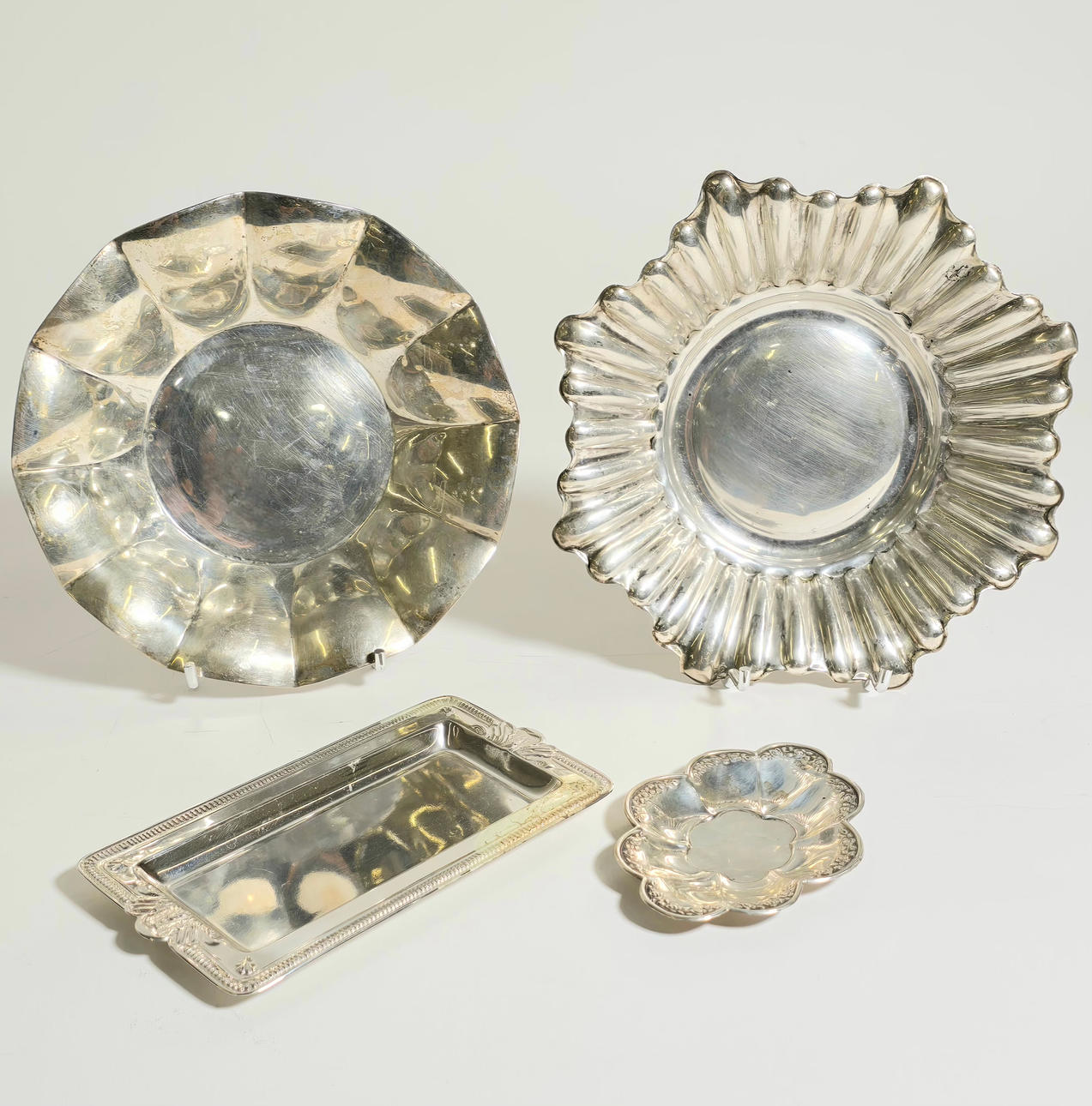 4 PUNCHED SILVER TRAYS.