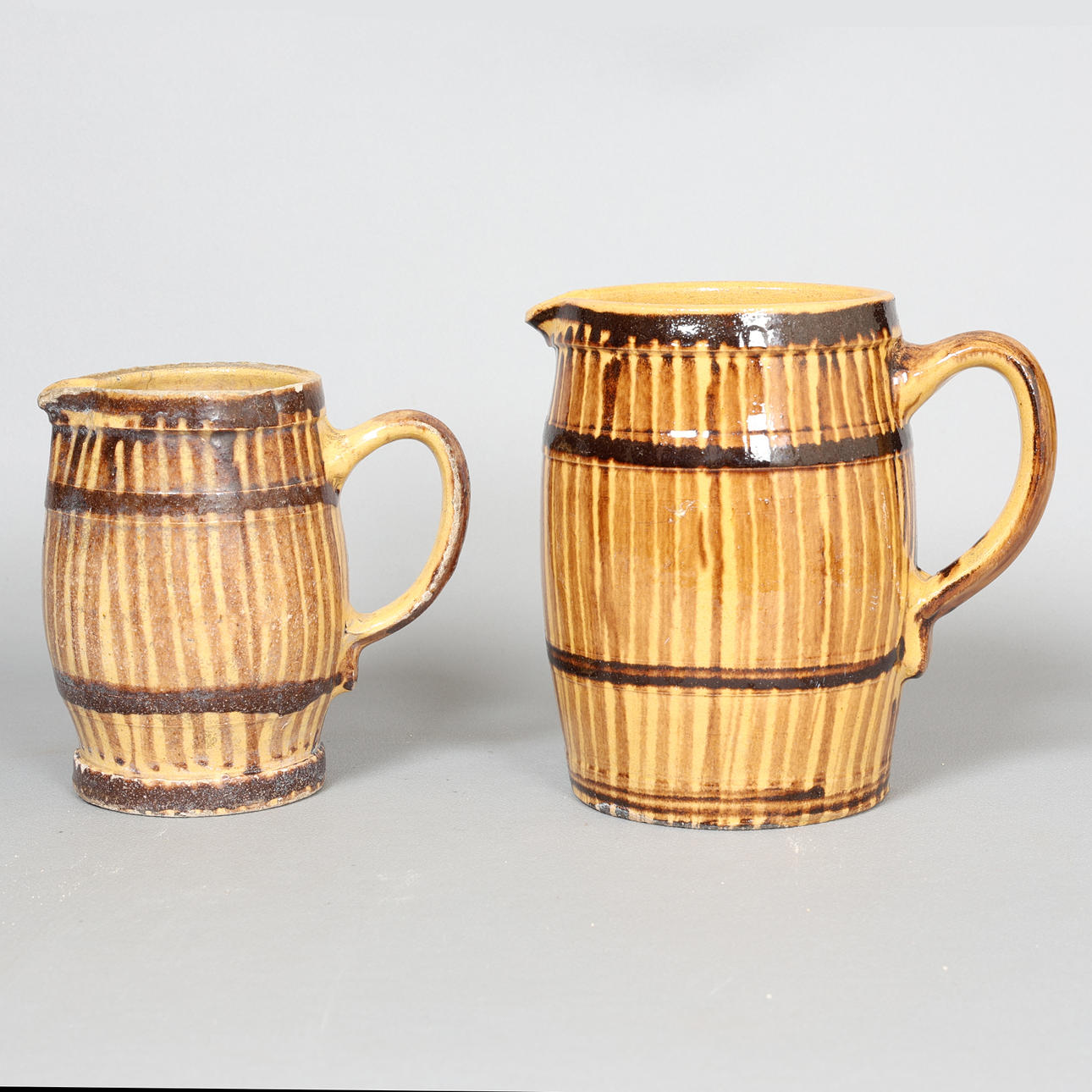 TWO 20TH CENTURY GLAZED BARREL FORM MUGS (2).