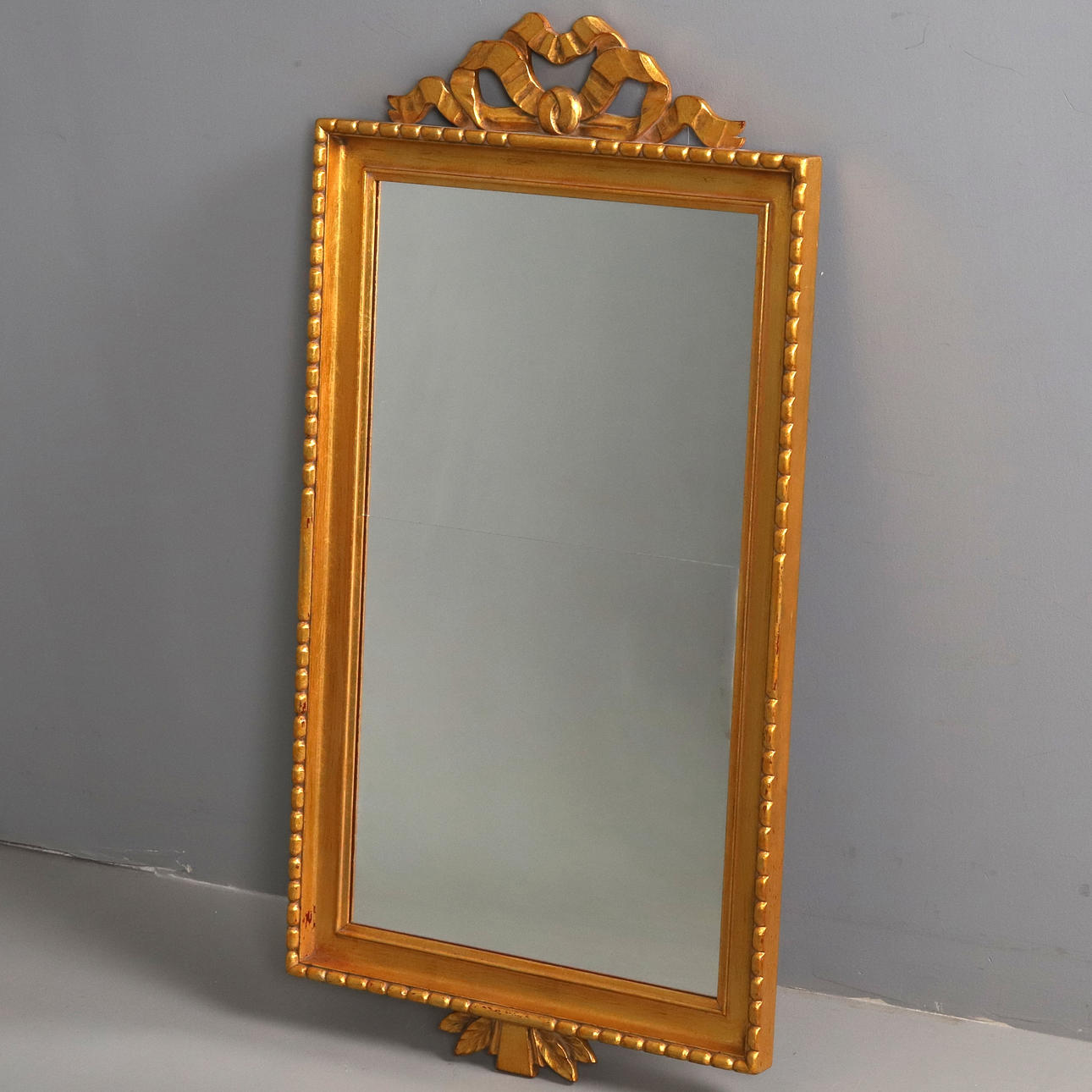 A GUSTAVIAN-STYLE MIRROR, 20TH CENTURY, SIGNED “TC”.