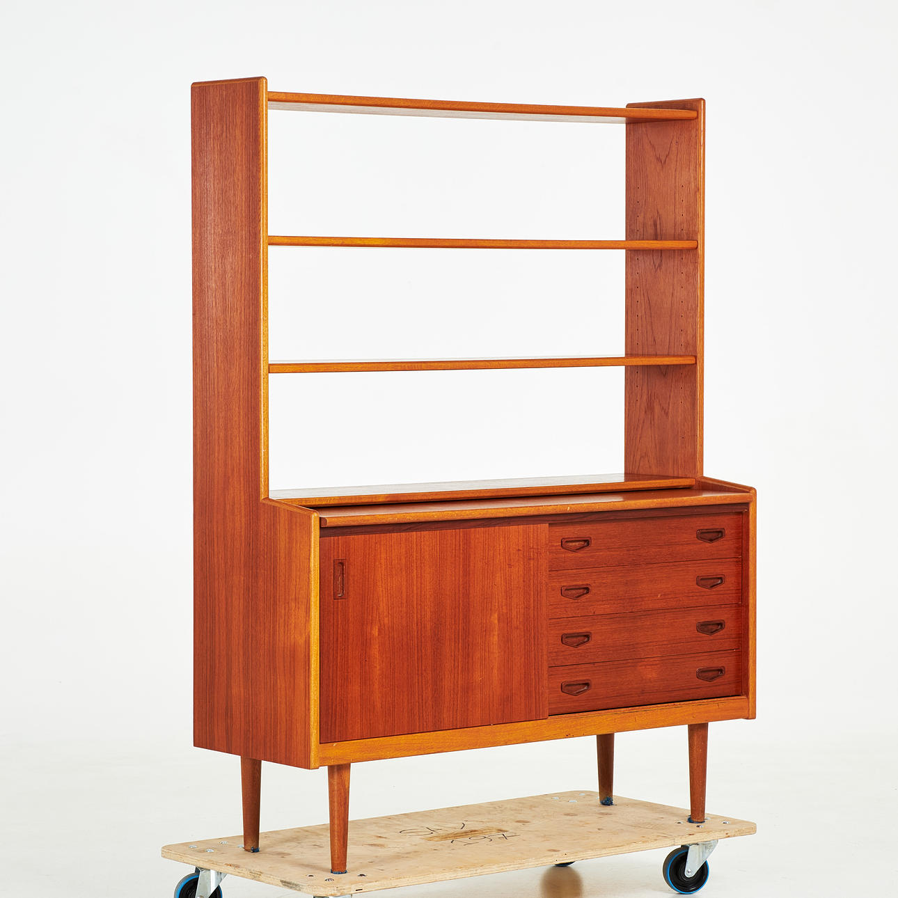 BOOKCASE. Mid 20th century, veneered in teak, edge profiles in oak, cabinet part drawers, desk top, shelf with two adjustable shelves.