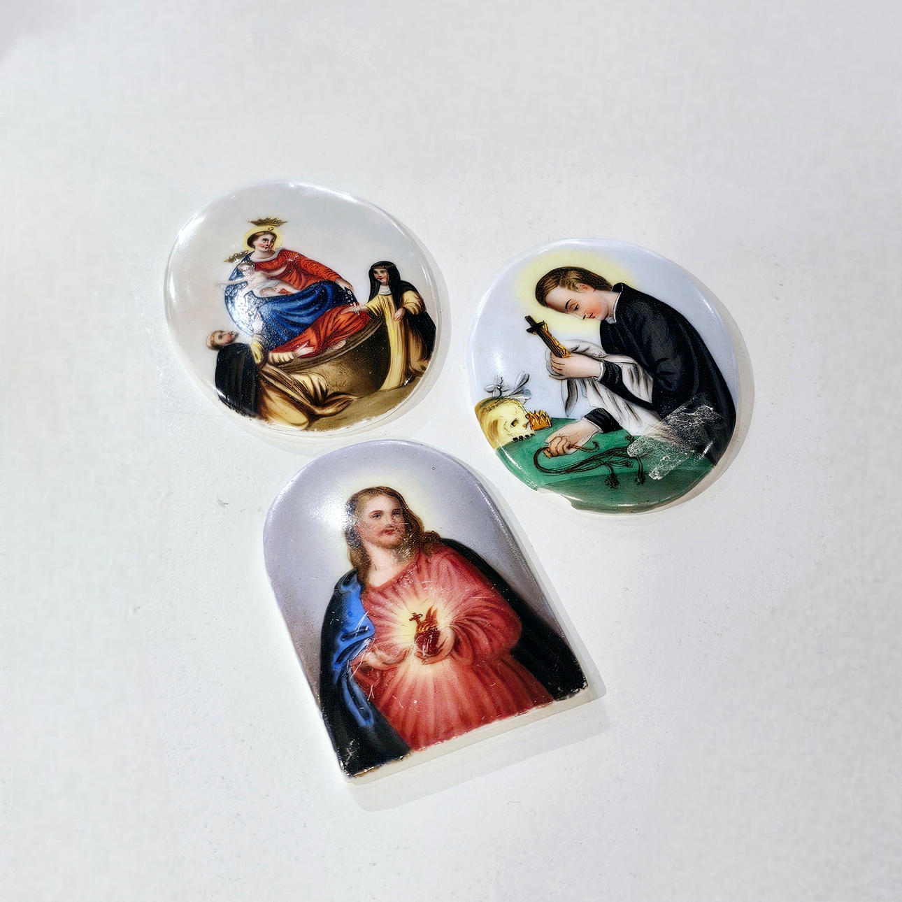 Three religious porcelain medallions.