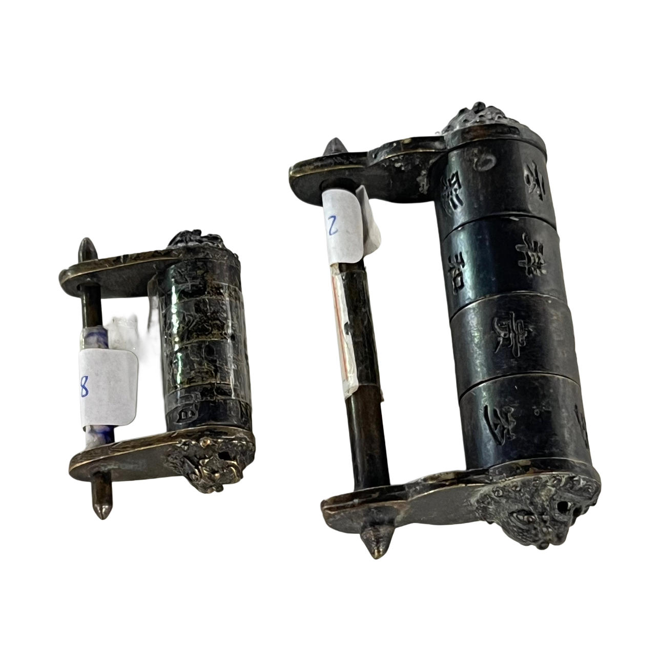 Two Chinese padlocks in patinated bronze.