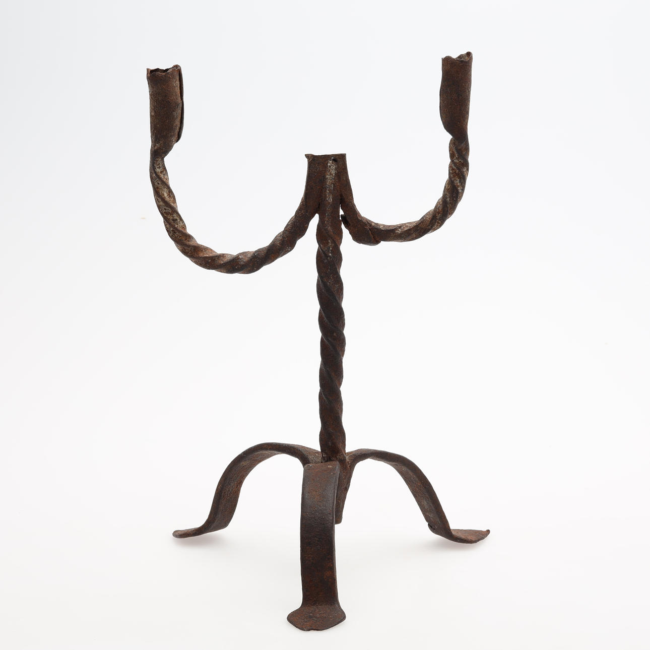 A 16th/18th century wrought iron candlestick.