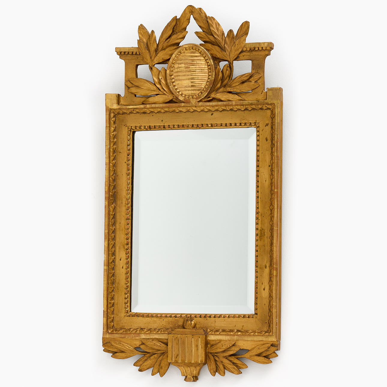 A late Gustavian mirror, cut wood, gilt and bronzed, later part of the 18th century.