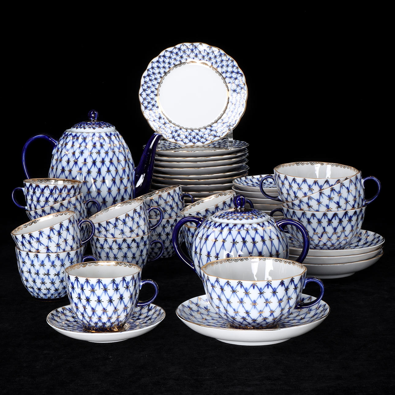 A set of 50 “Cobalt net” tableware parts, Lomonosov, Russia. Second half of the 20th century.