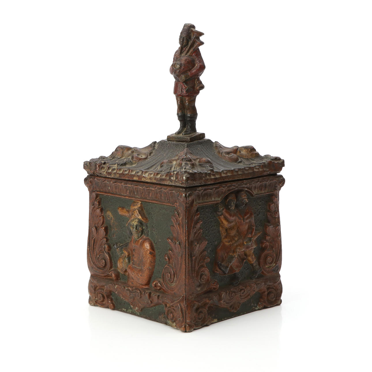 TOBACCO JAR. Painted cast iron. 18th/20th century. Lid knob in the form of man with bagpipe.