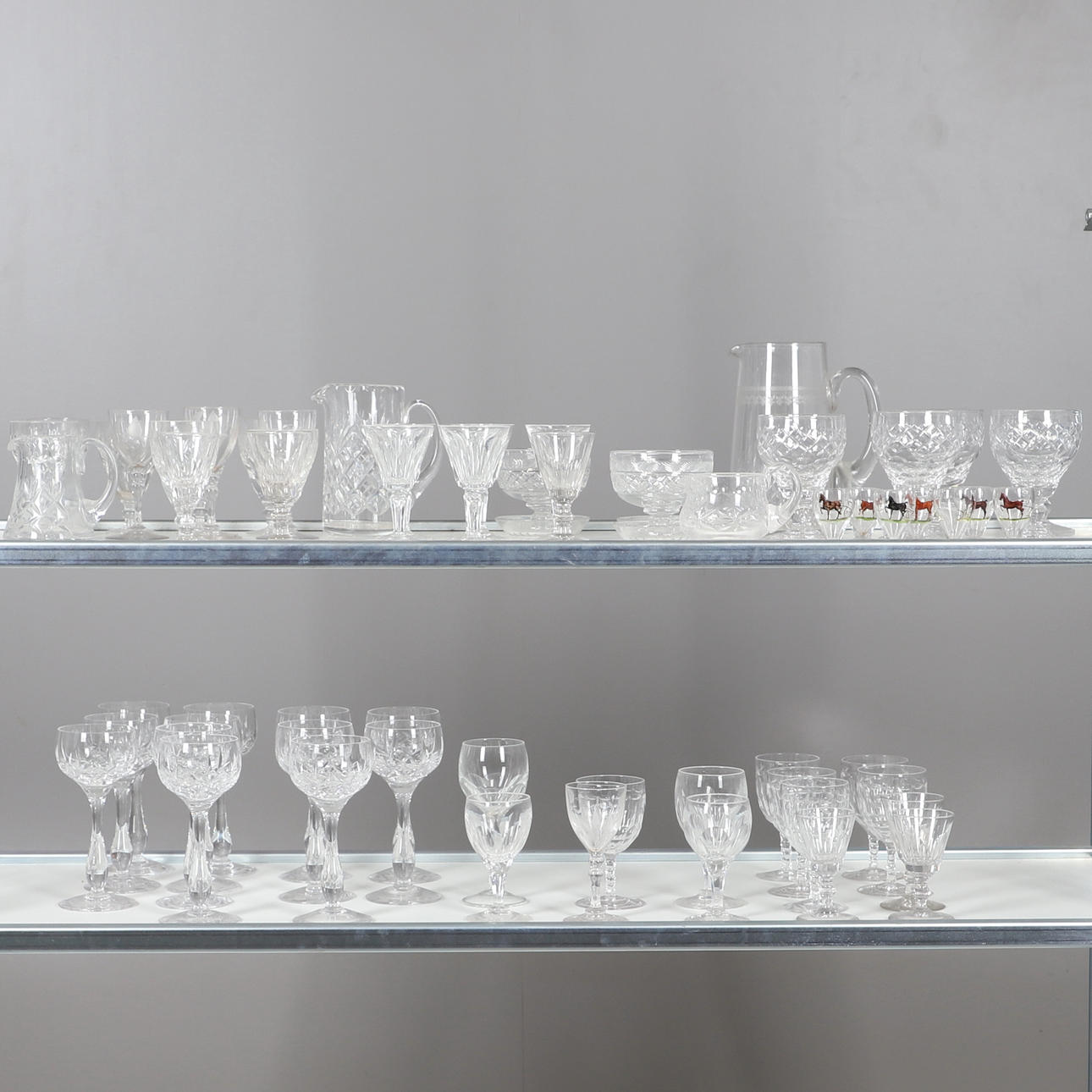 A QUANTITY OF ASSORTED CUT GLASS DRINKING GLASSES.