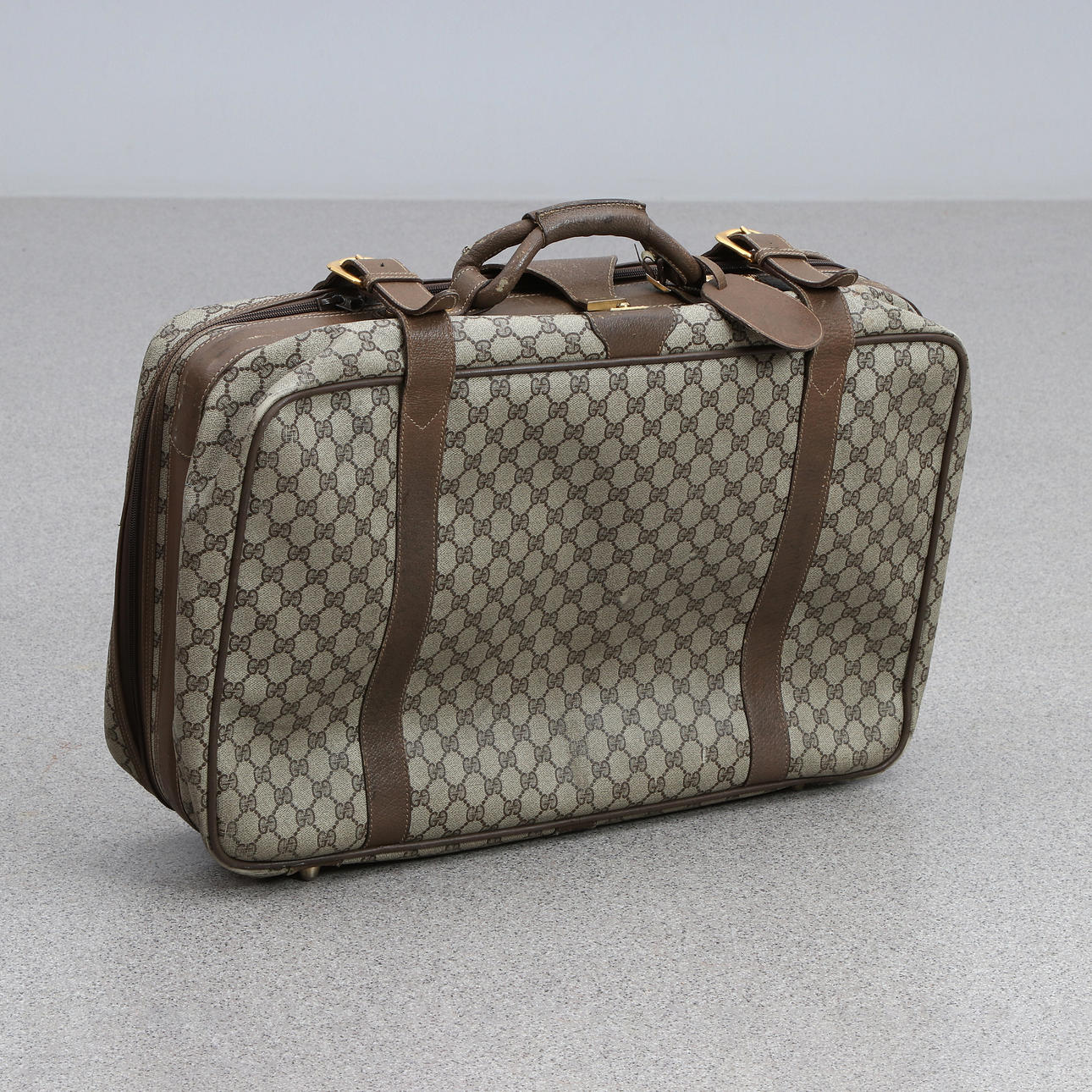 GUCCI, SUITCASE. Monogram canvas and leather details.