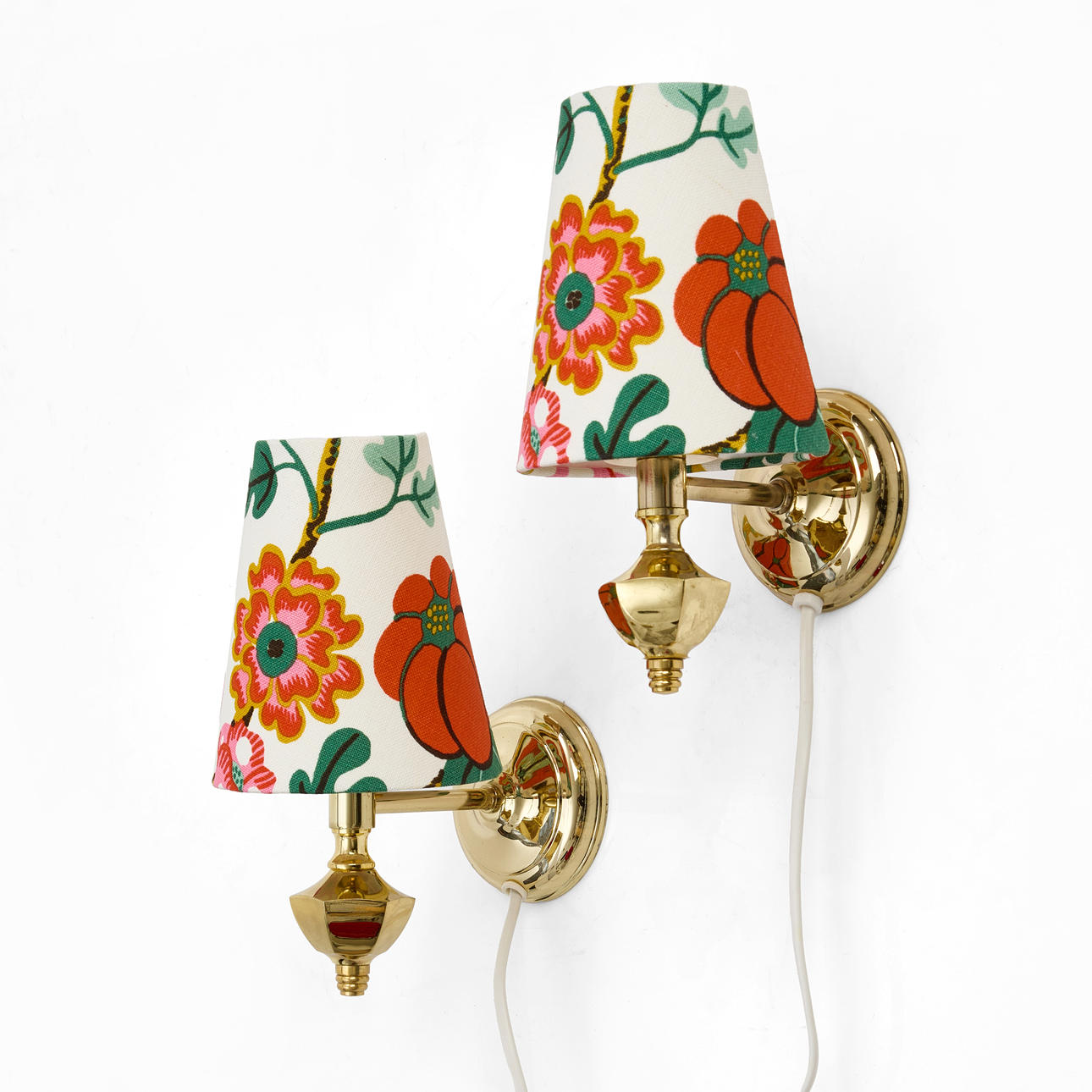 WALL LAMPS, a pair, brass, screens dressed in linen textile, pattern “Tree I Blom”, designed by Josef Frank for Firma Svenskt Tenn.