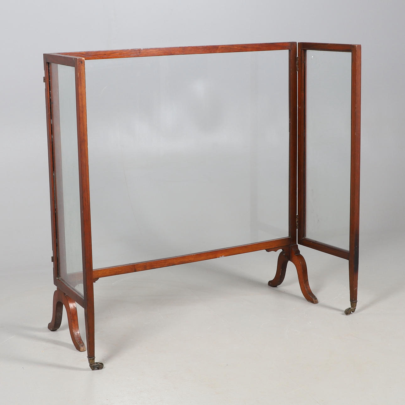 A MAHOGANY THREE FOLD GLASS SCREEN.