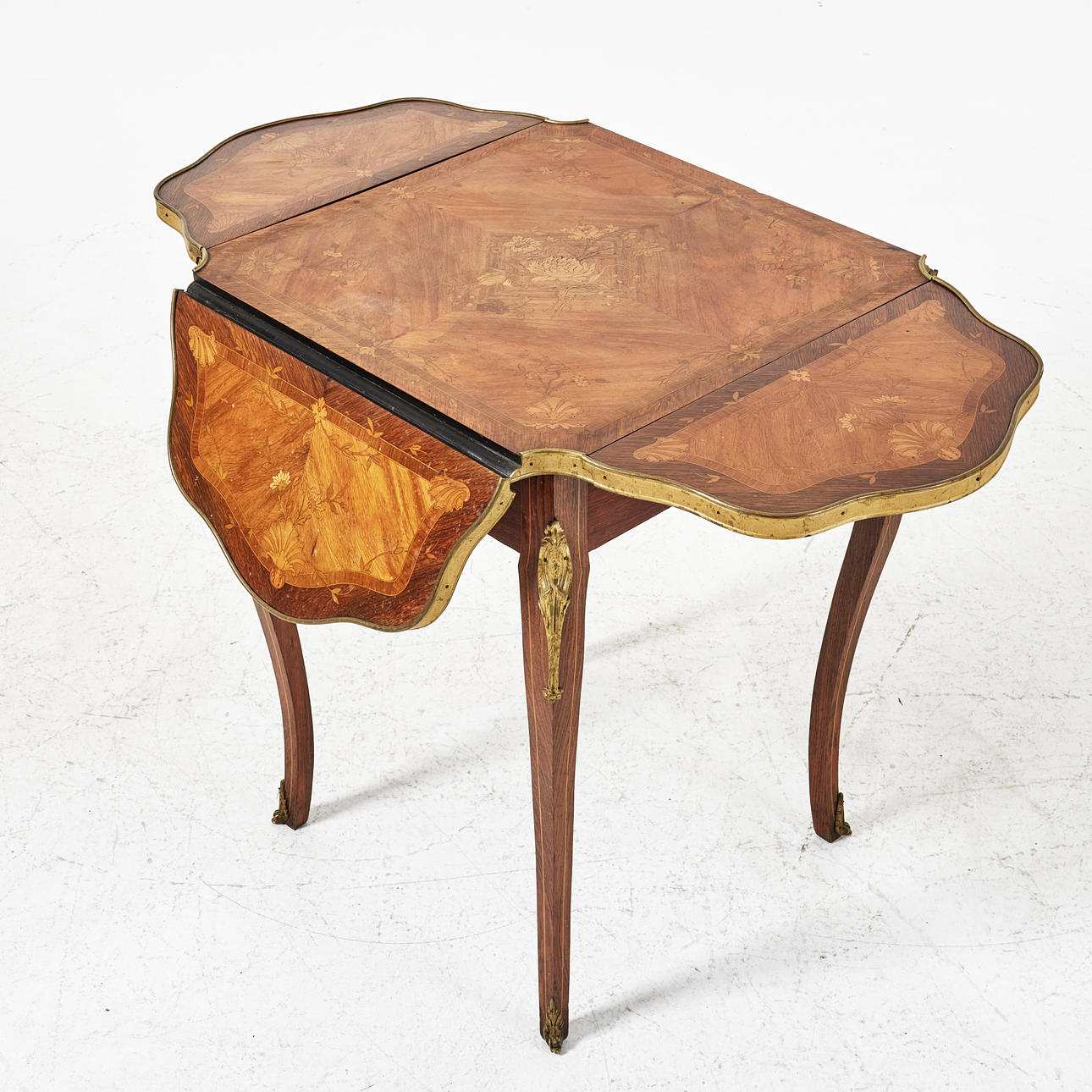 A folding table, early 20th century, Louis XV style.