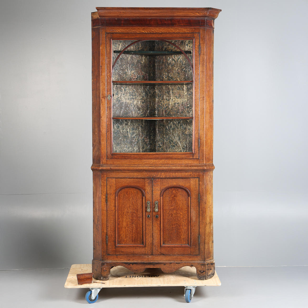 A GEORGE III OAK CORNER CUPBOARD.