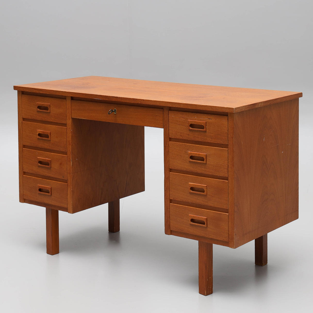 A 1950s/60s teak veneer desk.