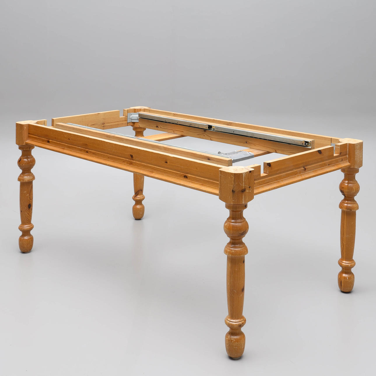 A 1970s/80's table base, pine, turned legs.