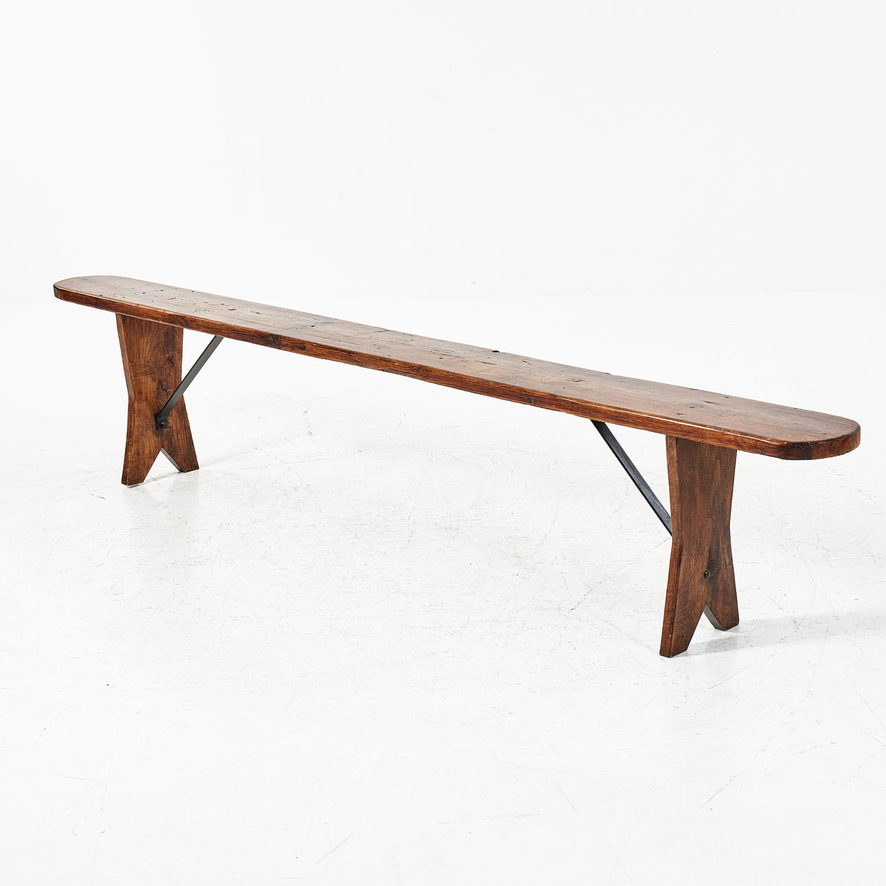 A 20th century oak bench with iron struts. Furniture - Other - Auctionet