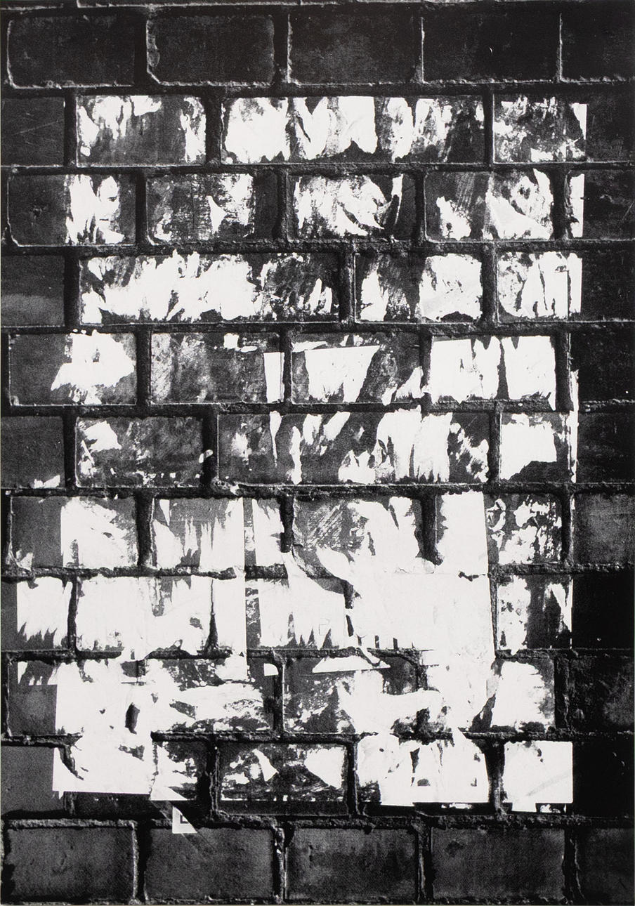 POSTER, screen printing, brick wall with poster remnants.