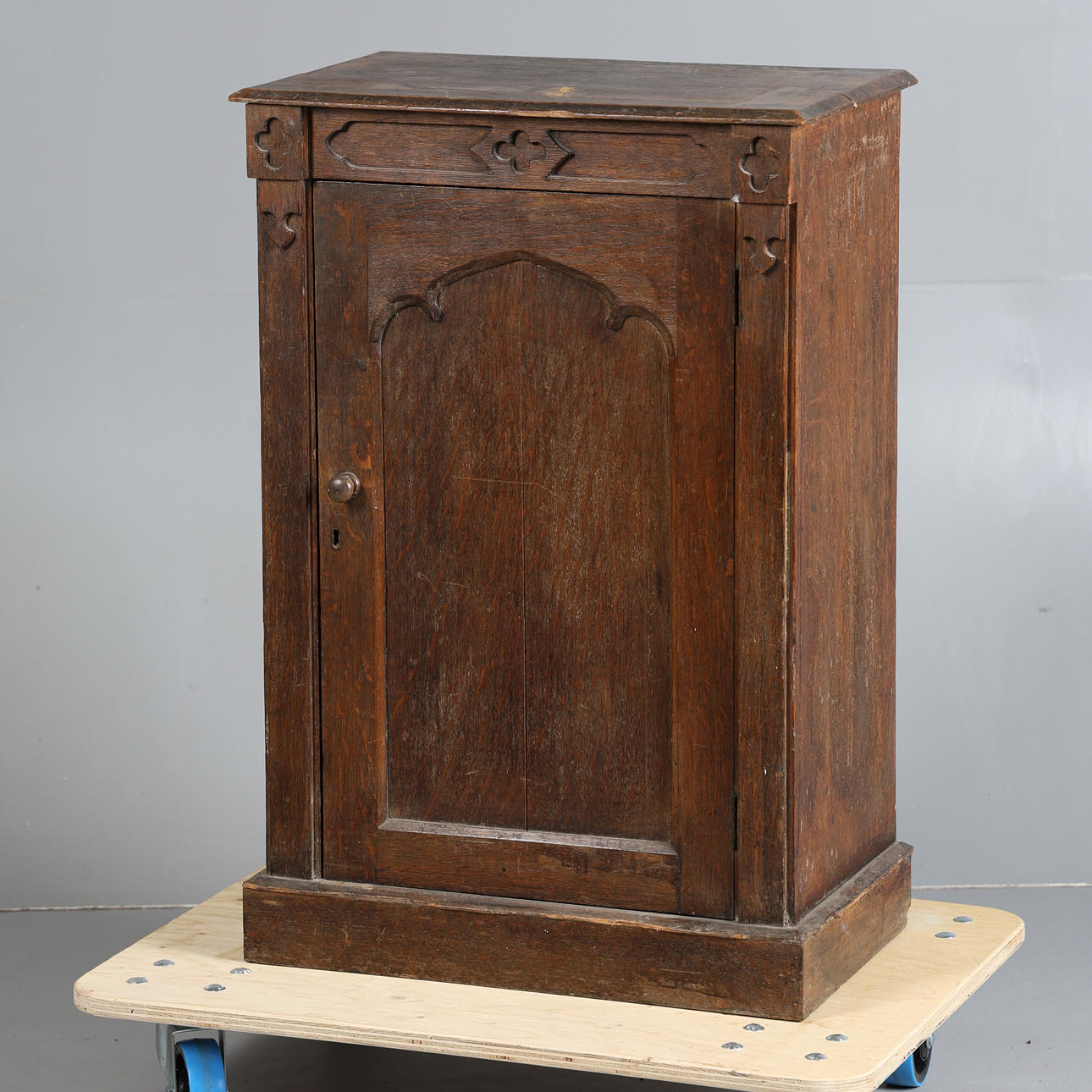 A VICTORIAN GOTHIC REVIVAL OAK CUPBOARD.