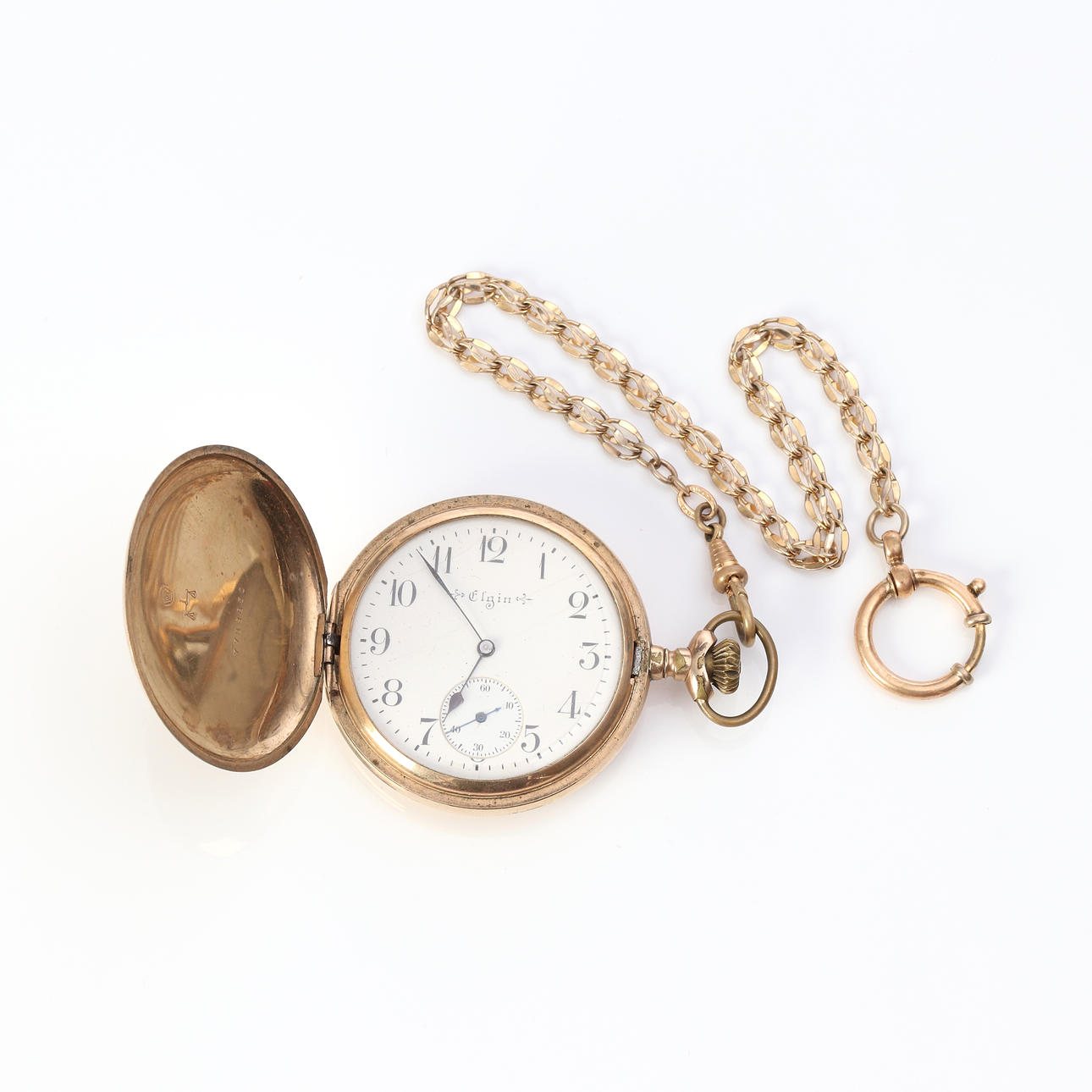 ELGIN, TASKUKELLO. Kotelo kultaisessa dublettissa.