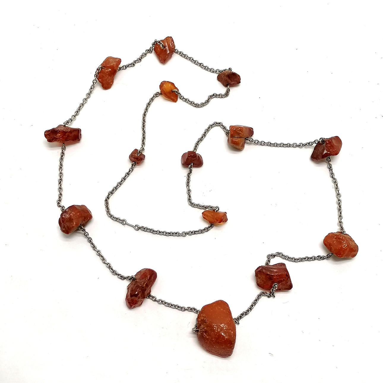 RAW AMBER BEAD NECKLACE ON SILVER CHAIN.