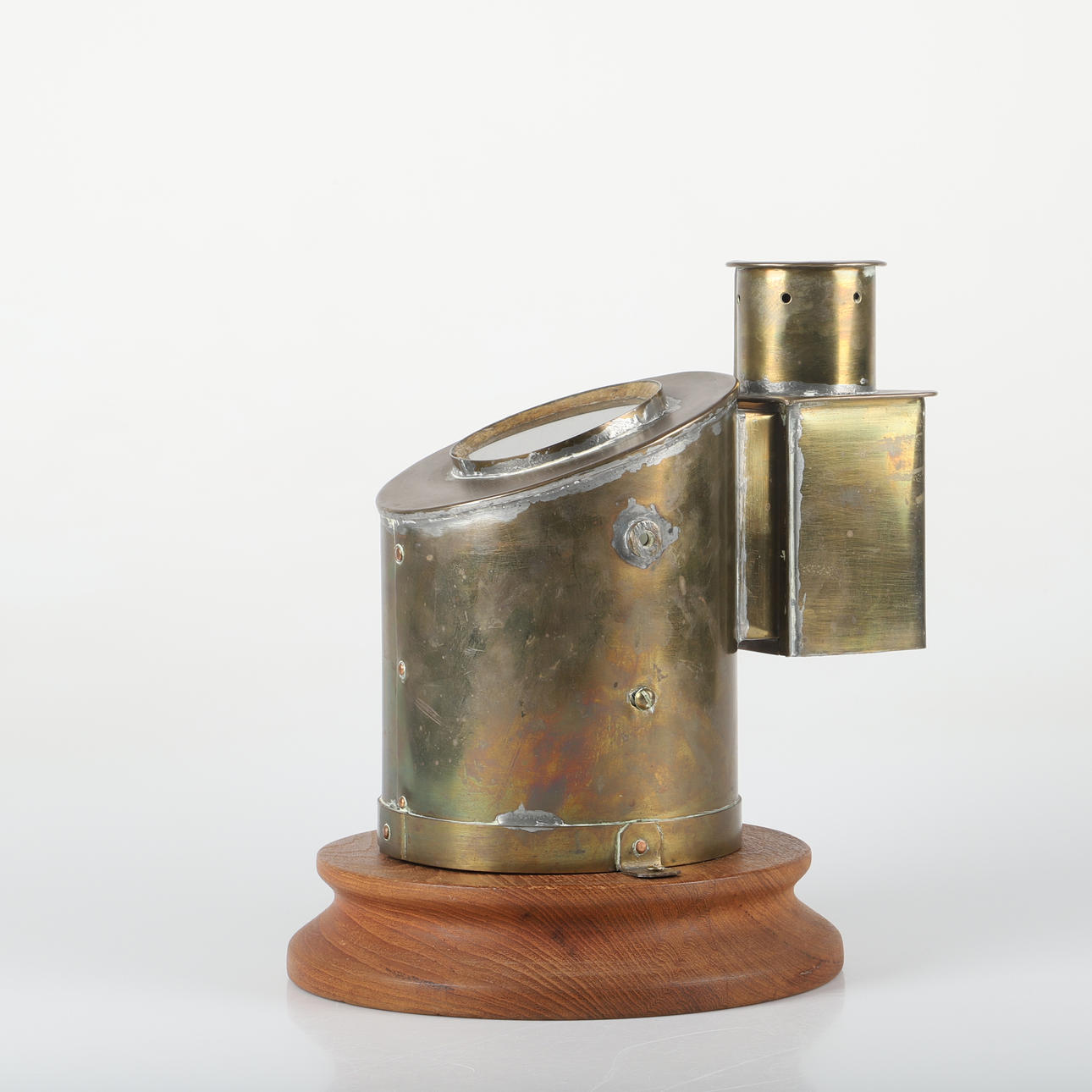 KOMPASS, brass on wooden plinth.