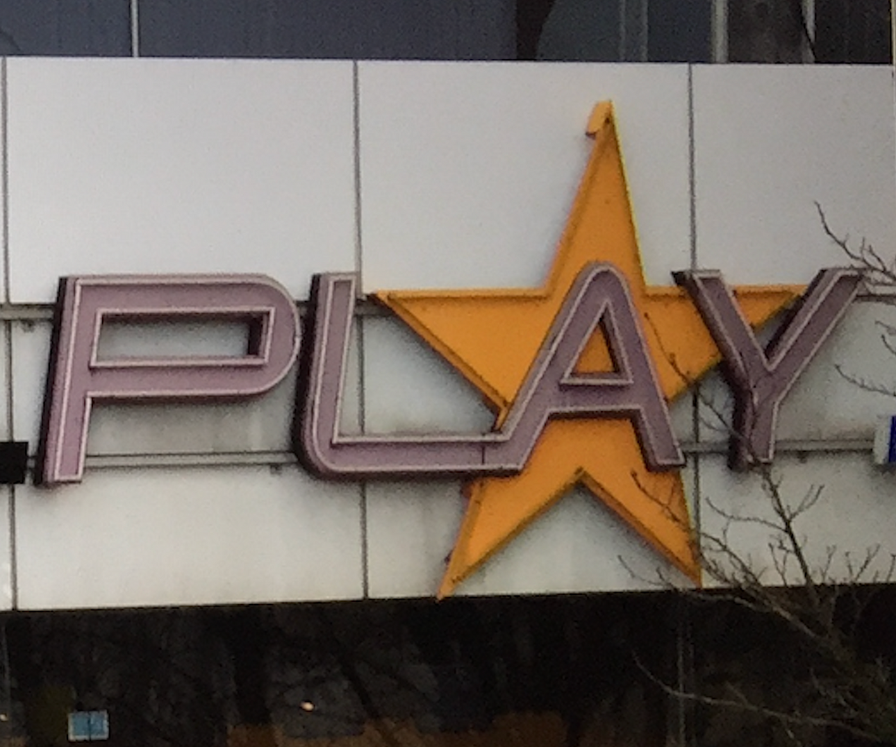 GIANT NEON LETTERS “PLAY”.