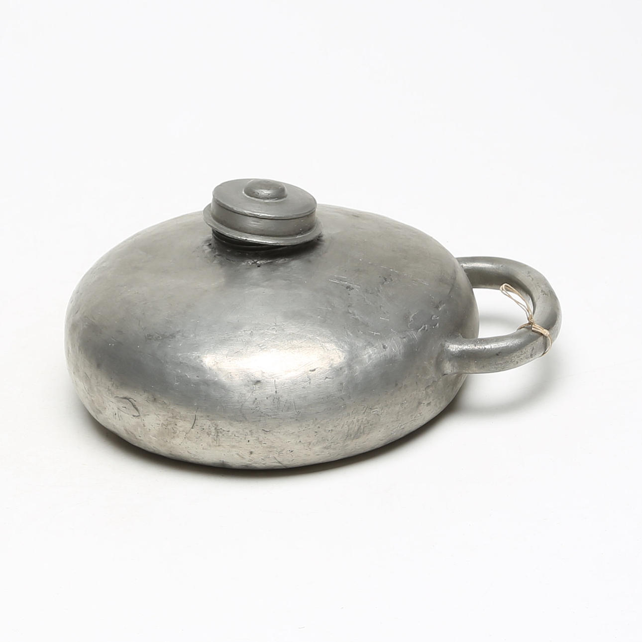 A pewter bed warmer, probably 19th century.