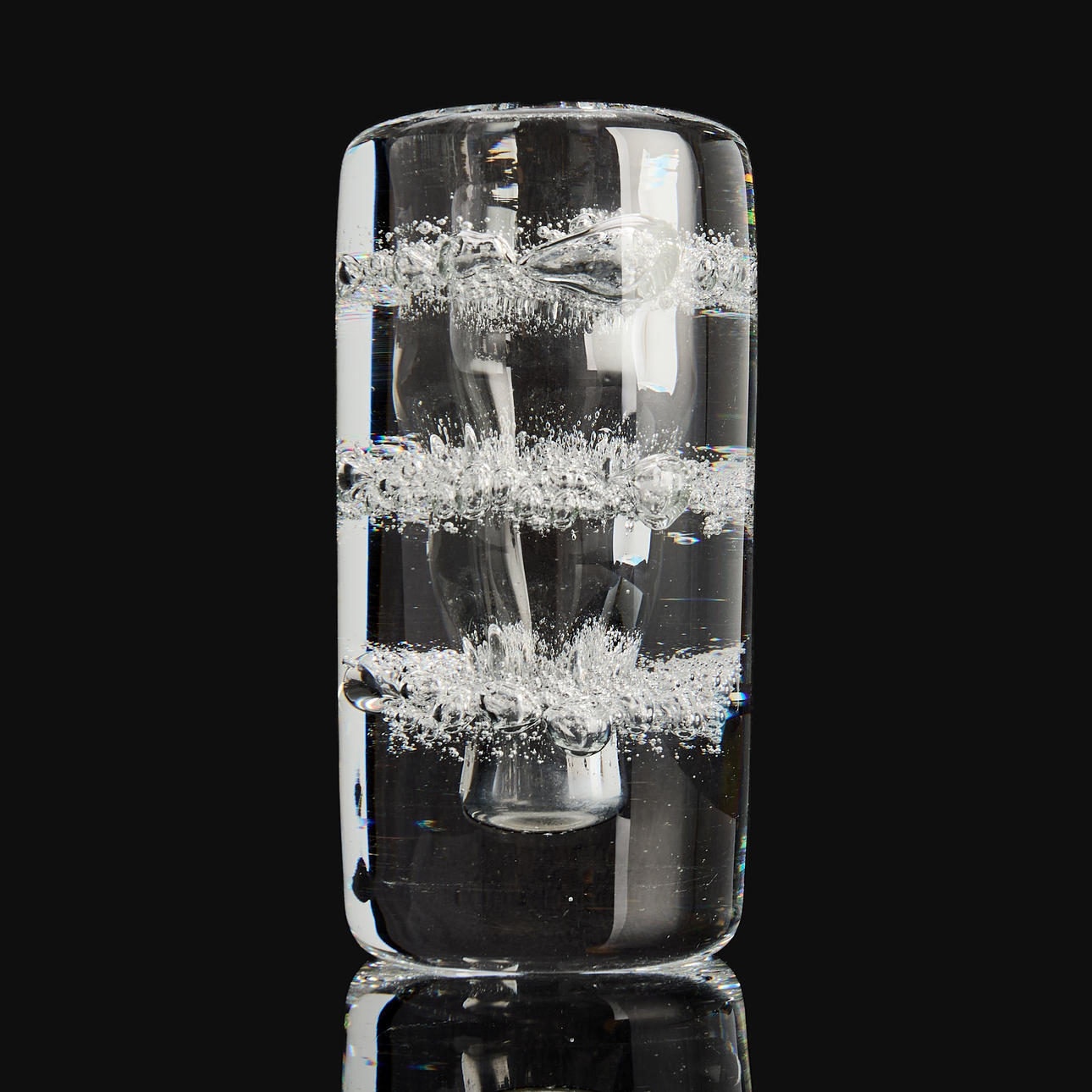 A thick-walled clear glass vase with enclosed air bubbles, likely Frantisek Vizner, Czechoslovakia.