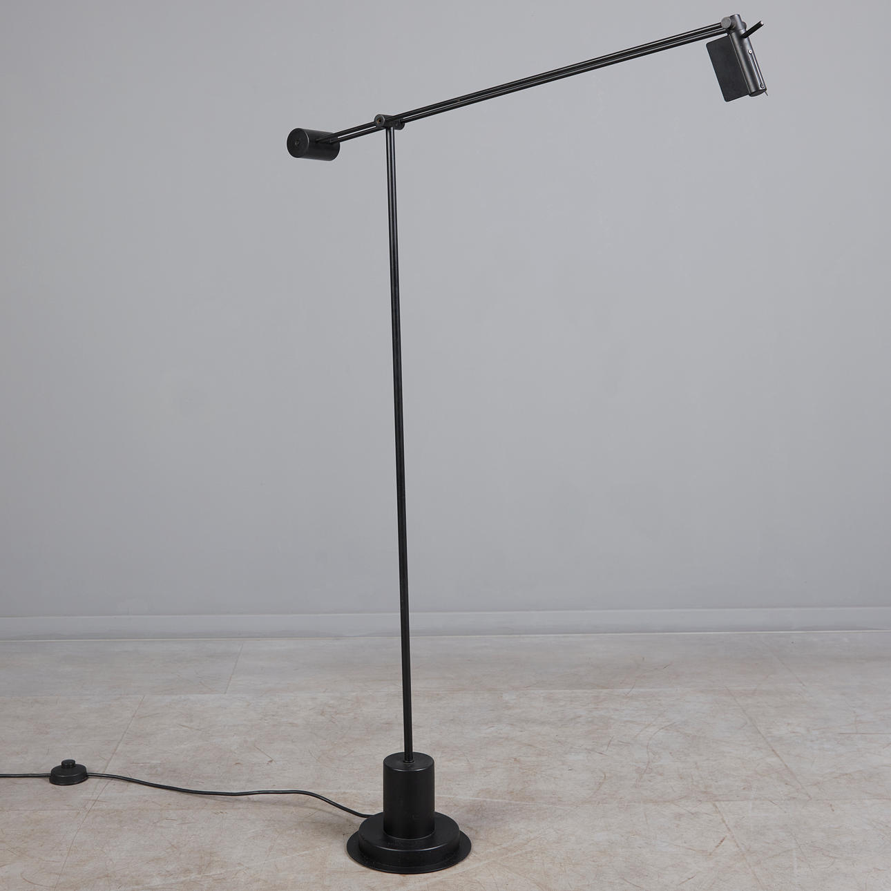 Black floor lamp in the style of Artemide.