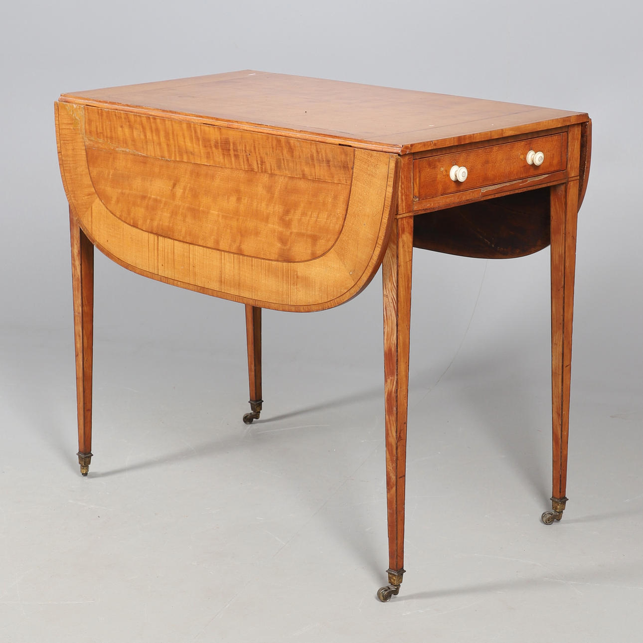 A 19TH CENTURY SATINWOOD PEMBROKE TABLE.