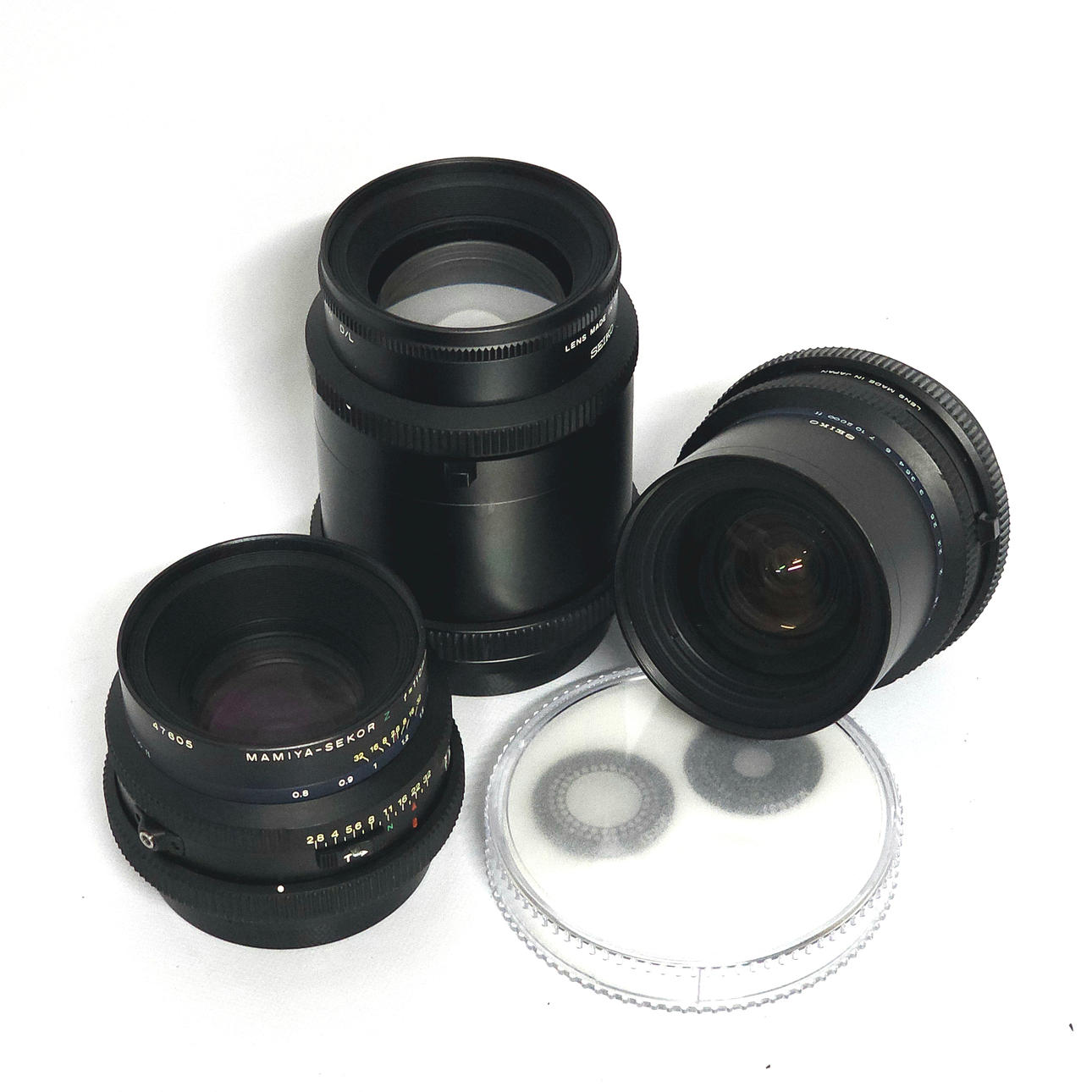 Three Mamiya objectives with accessories.