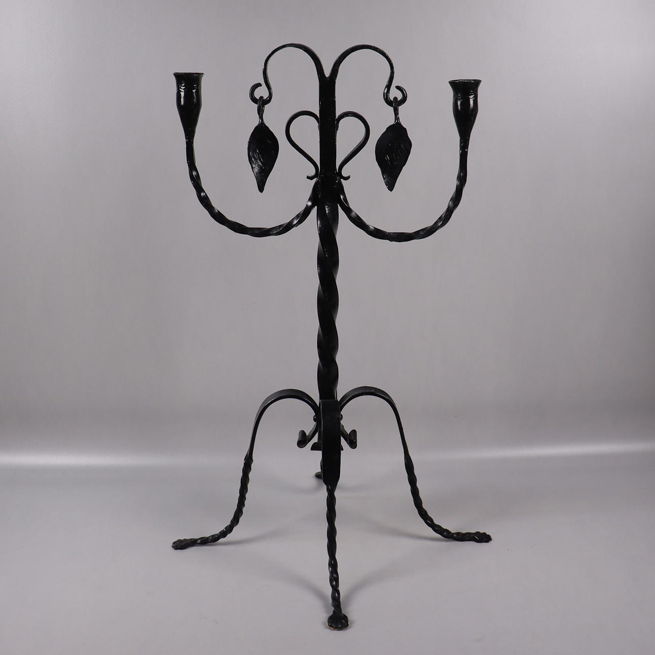 A wrought candlestick, 2 candle holders, 20th century.