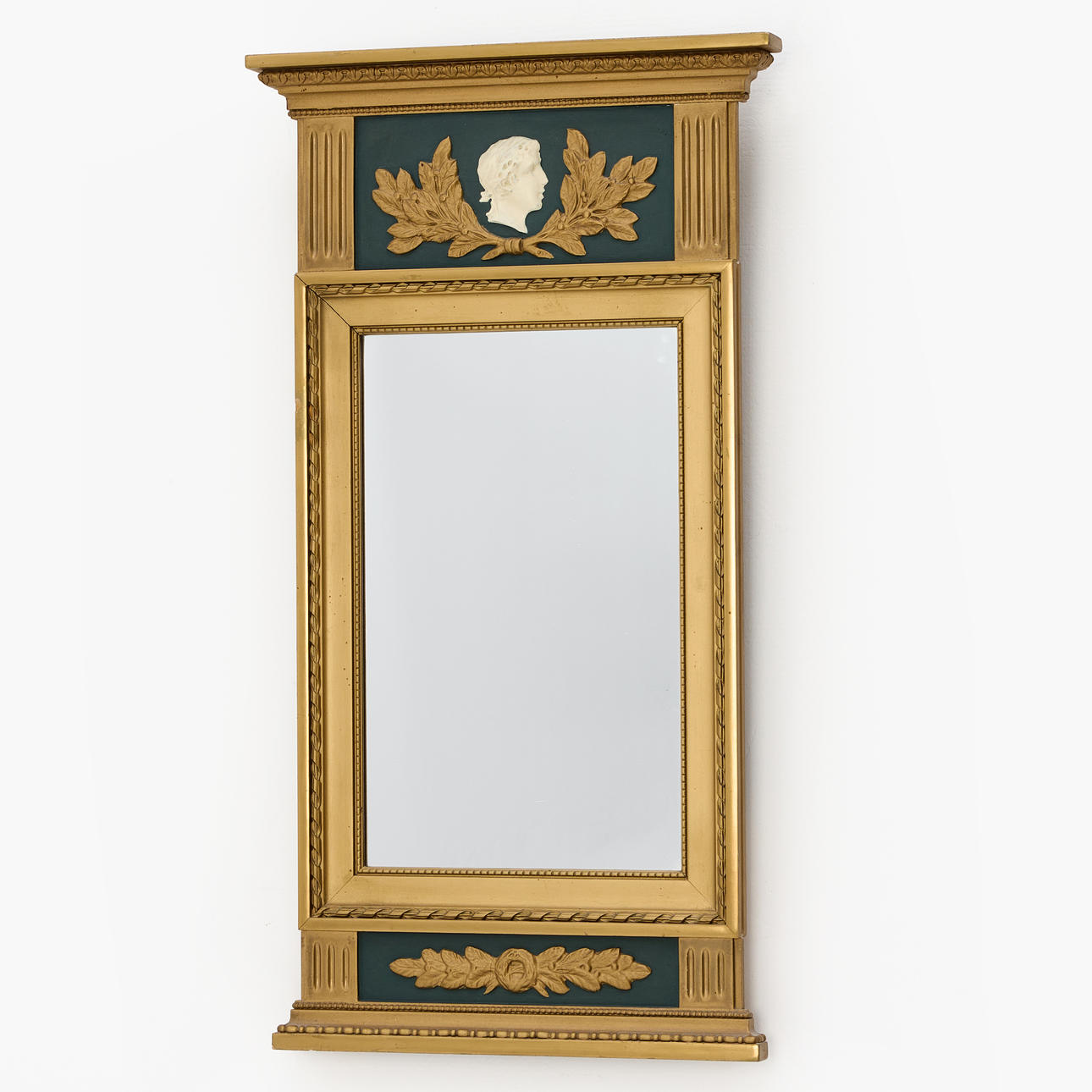 A Gustavian-style mirror, bronzed and painted frame with, crown with portrait and bay leaf.