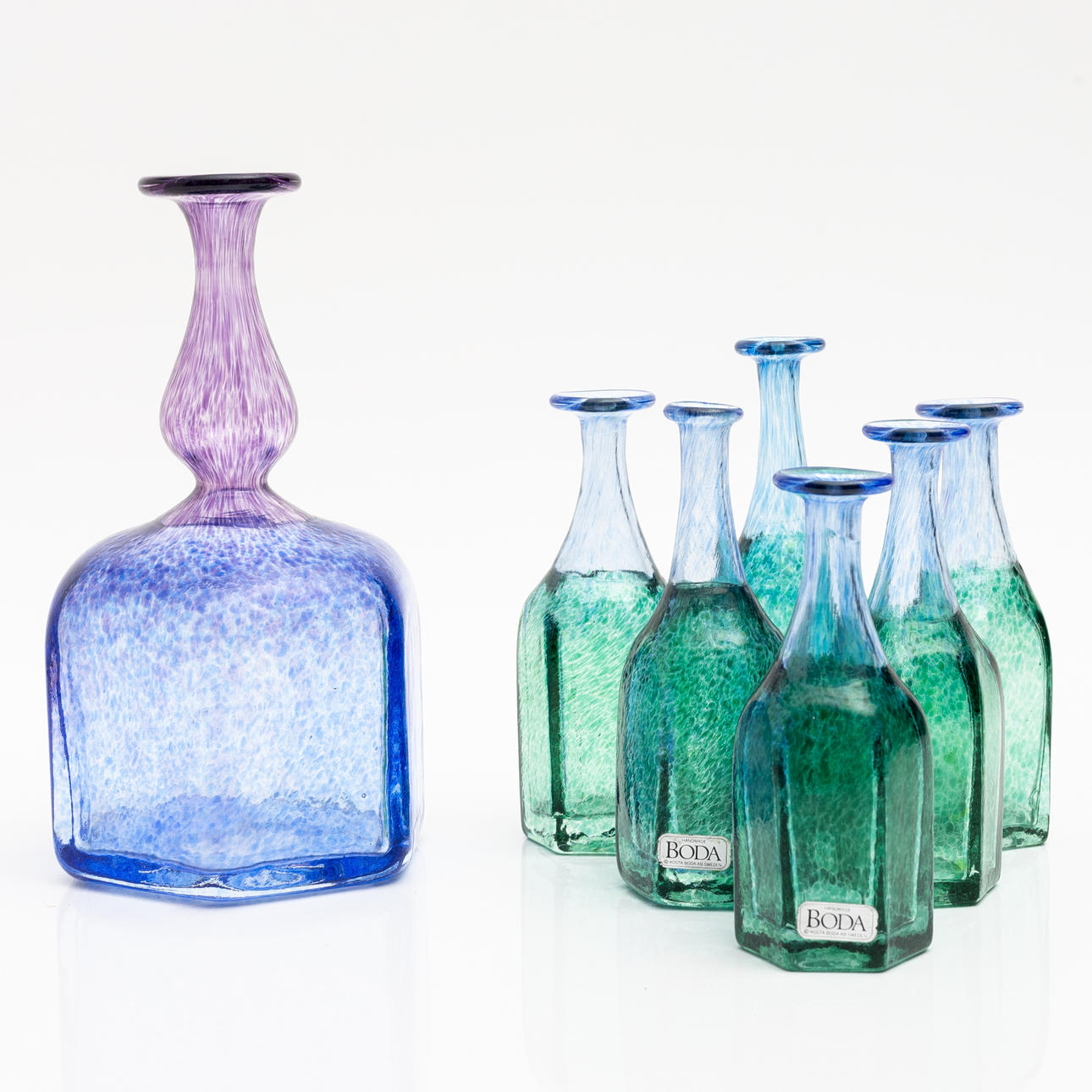 BERTIL VALLIEN. A set of 6+1 glass vases/bottles, from the series “Antikva”, signed, Kosta Boda.