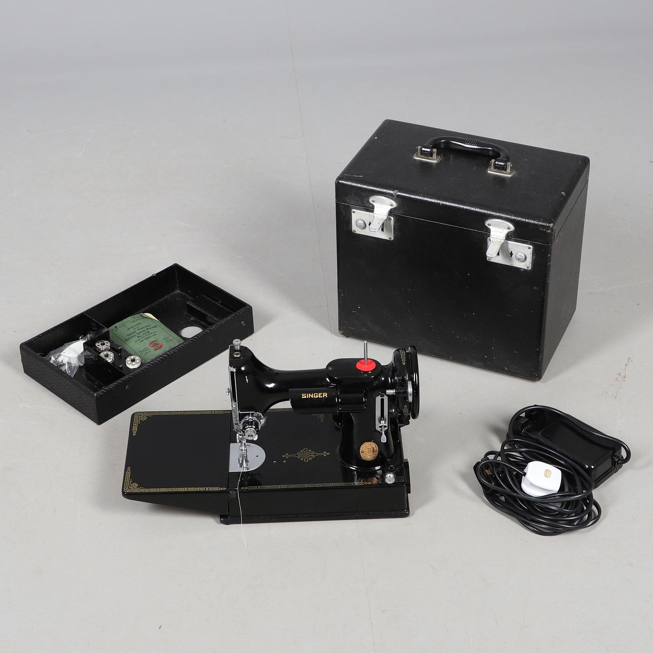 A CASED SINGER 221K SEWING MACHINE.